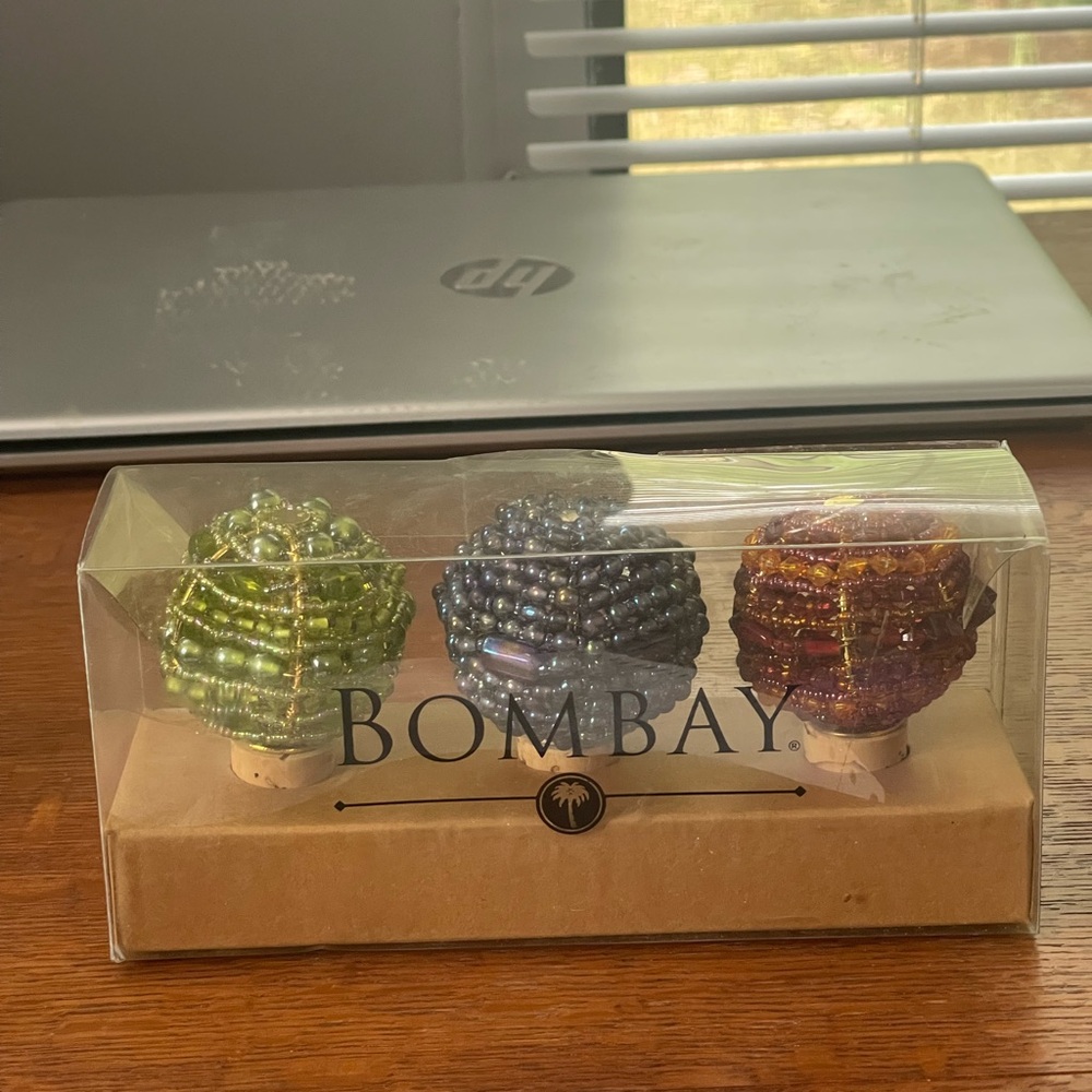 3 beaded bottle stoppers by the brand Bombay.